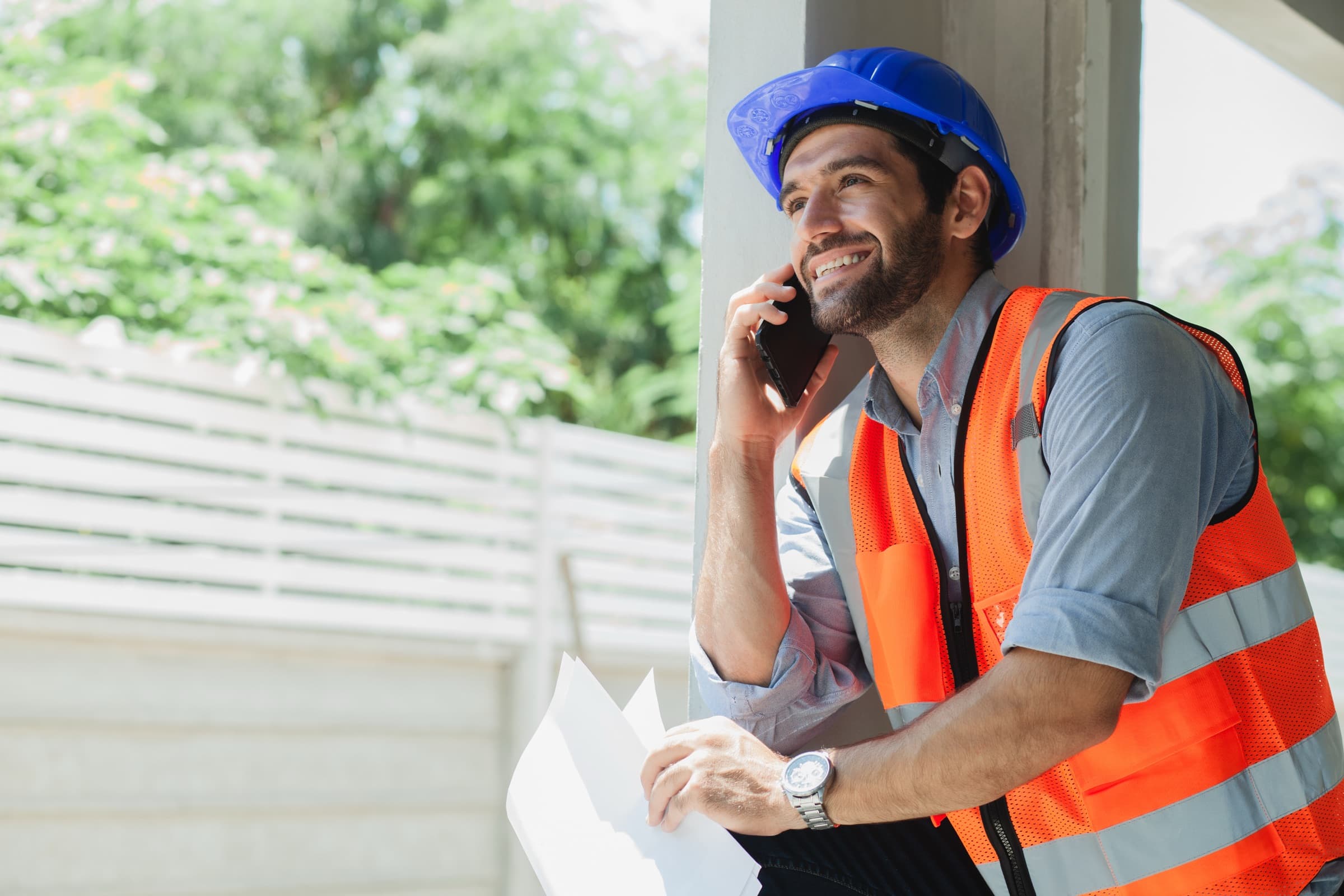 A contractor taking a call on a job site