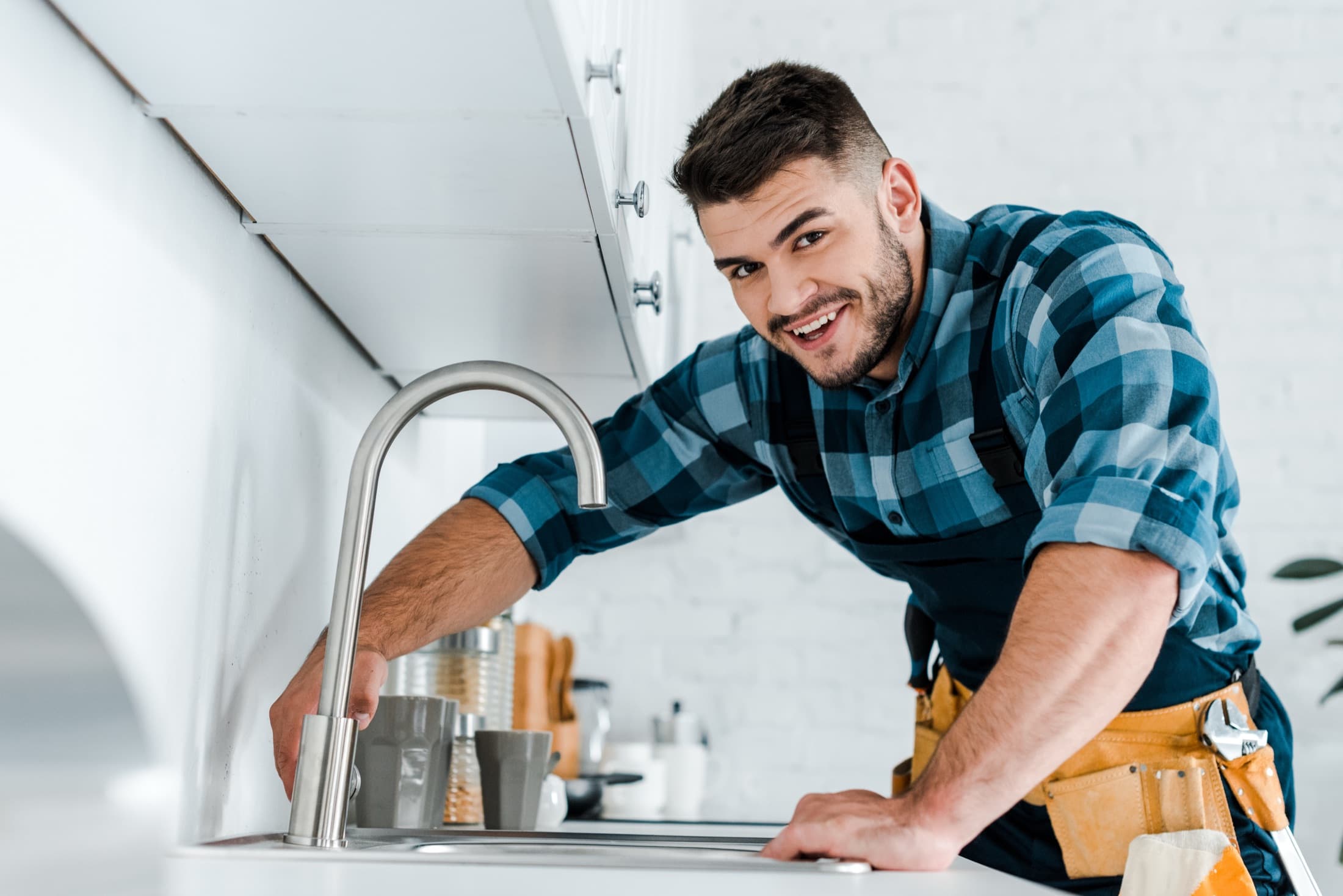 Plumber working at a kitchen sink