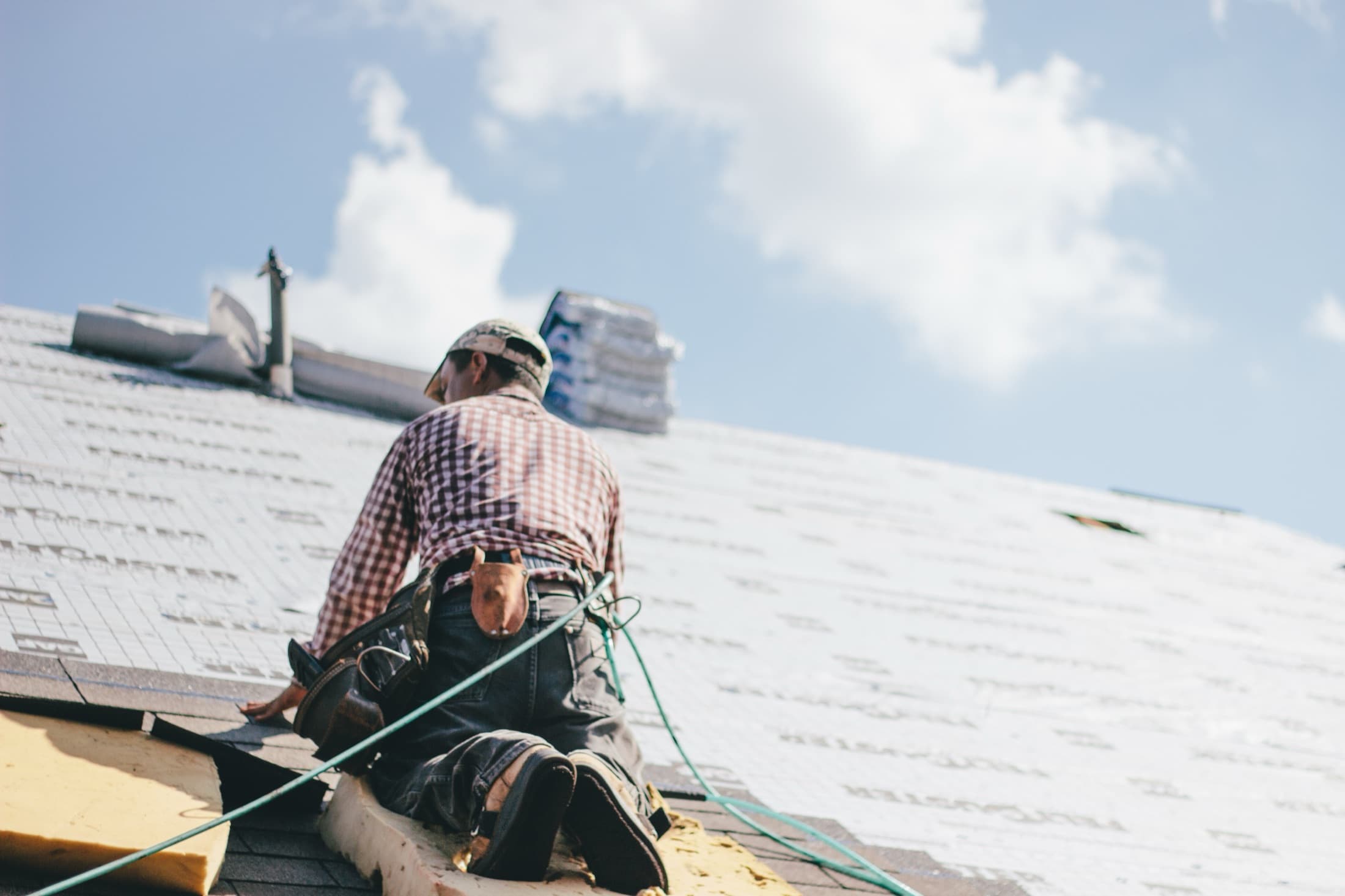 Roofing contractor installing a new roof